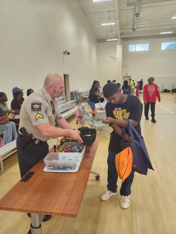 A student receiving gifts from an event.