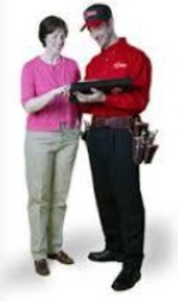 Woman standing with a serviceman holding a clipboard.