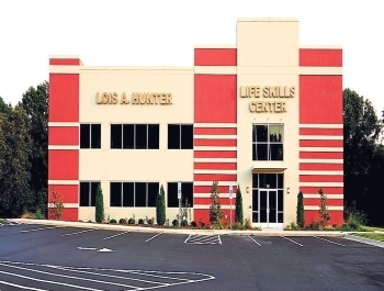 Outside view of the Lois A. Hunter Life Skills Center and parking lot.