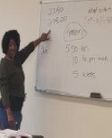 Lady at the whiteboard doing some tutoring.