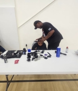 Barber gives a little boy a haircut.