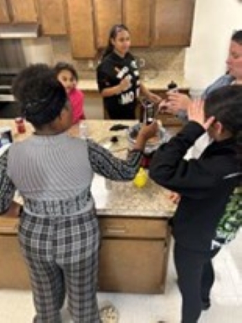THA residents standing around a kitchen island.