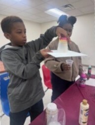 A young boy making an art project.