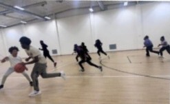 Kids running on a basketball court.