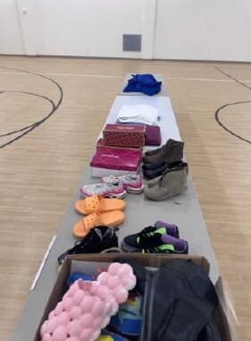 A view of clothes and shoes on a table.