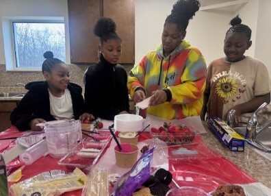 A group of 4 people making Valentine's Day desserts.