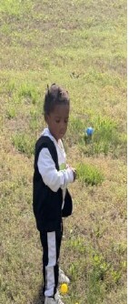 A young kid looking for eggs.