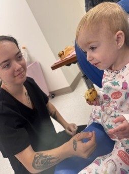 A young woman talking with a child.
