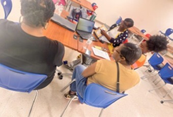People sitting in chairs at the Triple P Parenting program.