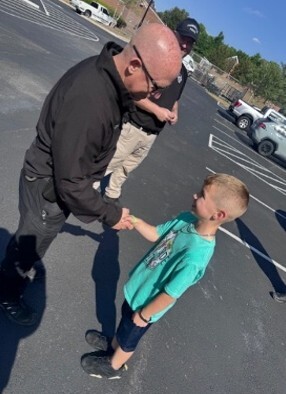 A man talking to a young boy.