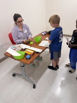 A young boy talking to a woman.