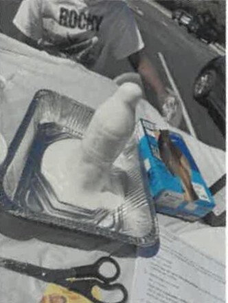 Melted marshmallow in a metal tin sitting in the sun.