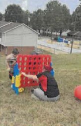 People playing with an oversized Connect 4.