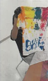 A person holding up a piece of tie dye fabric.