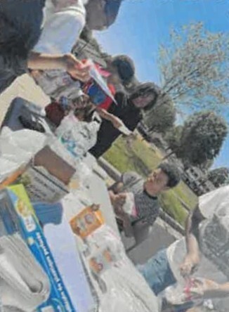 Four kids having fun making solar ovens.