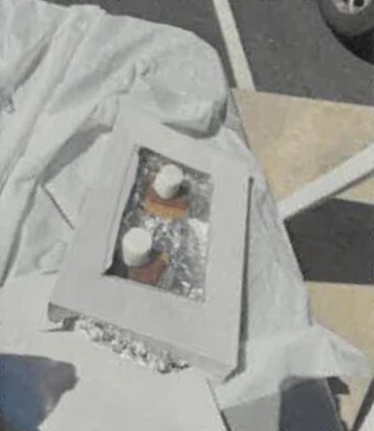 A solar oven sitting in the sun on a table.