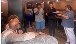 Five people gathered around talking.