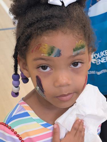 A young girl with face paint.