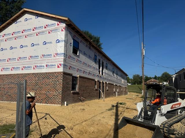 301 James Avenue with construction workers.