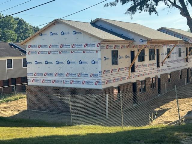 A side view of the 301 James Avenue building with the exterior bricks half way done.
